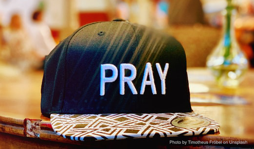 baseball cap with 'PRAY' on it